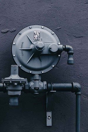 Professional plumber fixing kitchen sink faucet